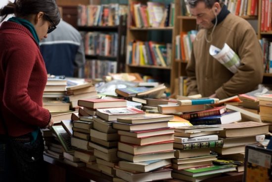 Students sorting through stacks of books