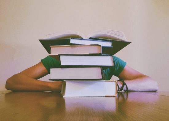 Student studying too many books