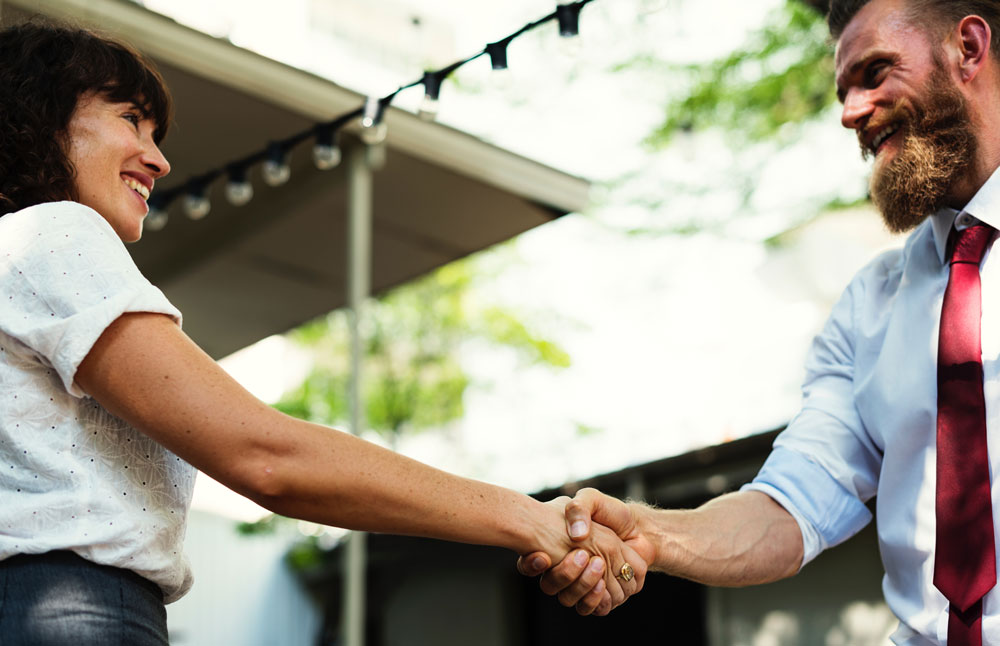 man and women shaking hands